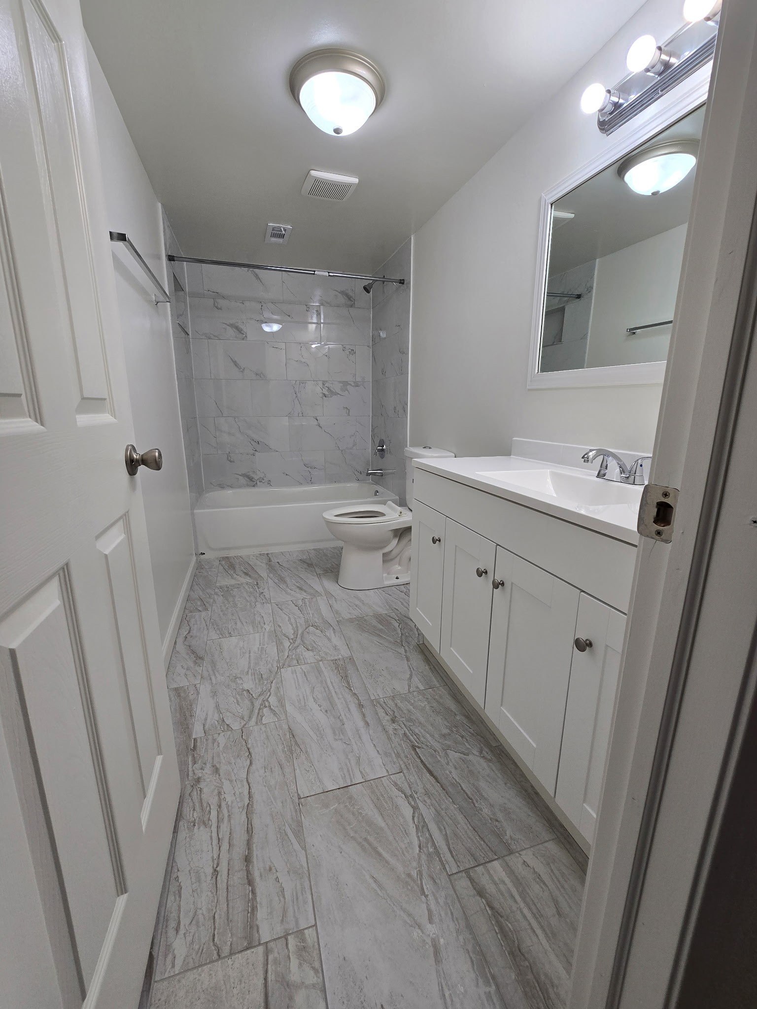 A bathroom with a toilet, sink, and shower.